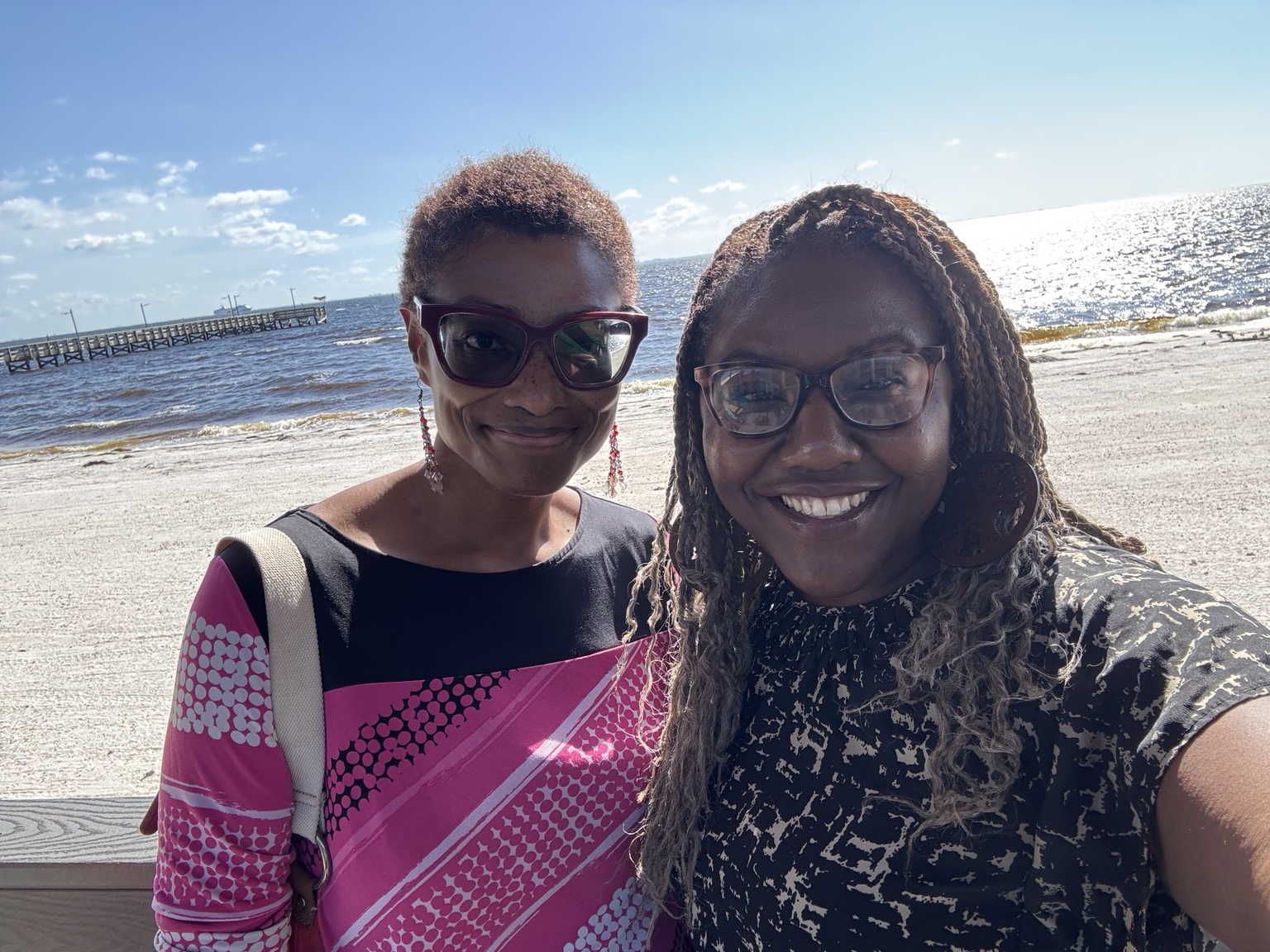 Dr. Sherry-Ann Brown and Rikkia smiling together during a waterfront outing