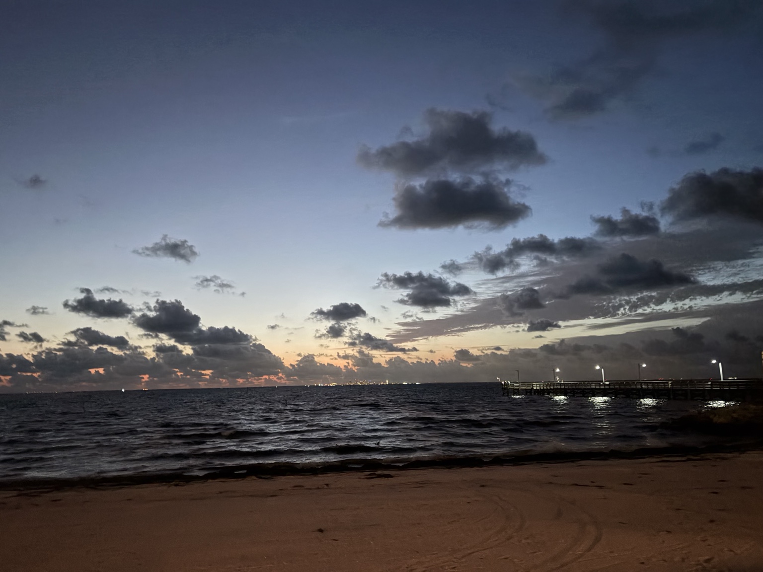 Twilight settling over the waterfront and illuminated pier during the residency week